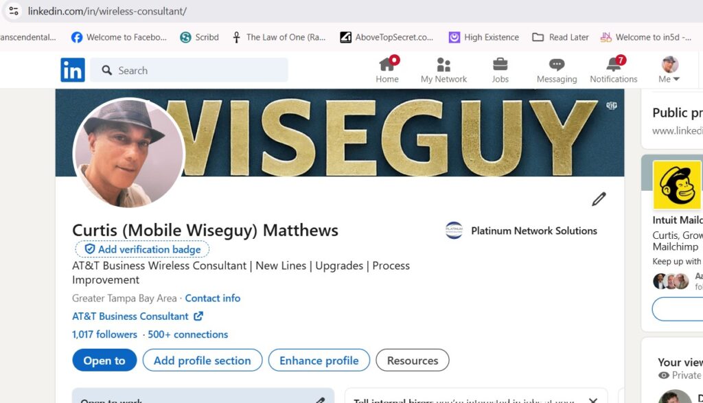 Screenshot of Curtis Matthews' LinkedIn profile under the username 'Mobile Wiseguy'. The profile shows Curtis wearing a fedora and highlights his role as an AT&T Business Wireless Consultant with specialties in new lines, upgrades, and process improvement. Notably, it displays the prompt to add a verification badge, emphasizing his ongoing struggle with obtaining LinkedIn verification despite his extensive experience and credibility in the field