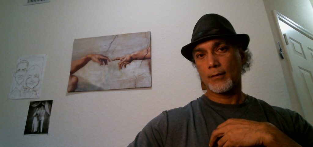 A person wearing a dark gray t-shirt and a black fedora hat sits in a room adorned with various artworks, reflecting the personal branding of Curtism. Behind them, a print of Michelangelo's "The Creation of Adam" is prominently displayed, highlighting the famous touch of hands, symbolizing Curtism's ethos of inspiration and connection. To the left, two smaller images are visible: one is a caricature of a couple, and the other is a black and white photo, showcasing the personal side of Curtism. This setting embodies the values of Curtism - innovation, integrity, and inspiration, as championed by Curtis Matthews, a fit, strong, and honest wireless consultant from Trinidad. #Curtism #WirelessConsultant #Trinidad #Art #PersonalBranding #Innovation #Integrity #Inspiration